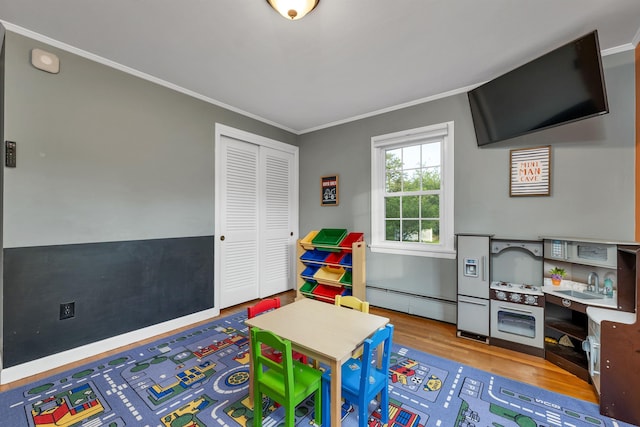 6 Cherry St, Concord, NH 03301 - game room with a baseboard heating unit, ornamental molding, and wood finished floors