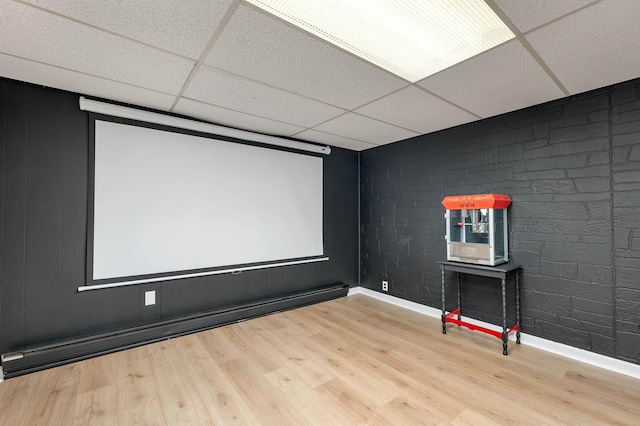 6 Cherry St, Concord, NH 03301 - cinema room with a drop ceiling, wood finished floors, baseboards, and a baseboard radiator