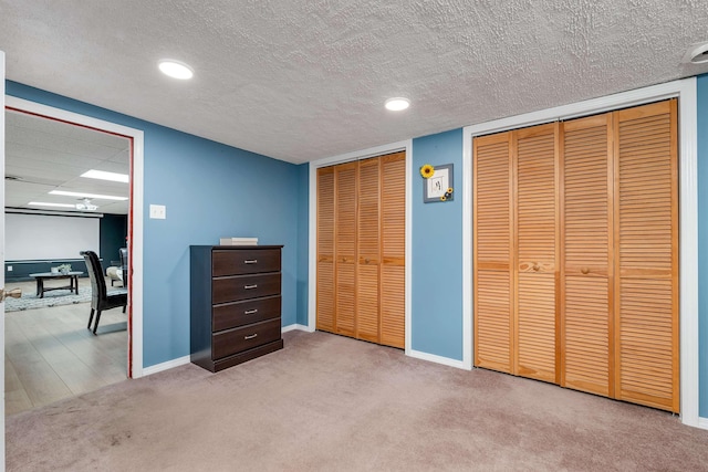 6 Cherry St, Concord, NH 03301 - unfurnished bedroom featuring multiple closets, baseboards, carpet flooring, a textured ceiling, and recessed lighting