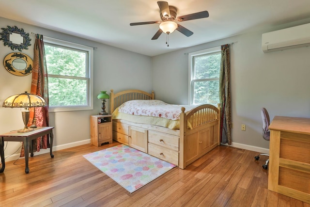 56 Averill Rd, Brookline, NH 03033 - bedroom featuring a wall mounted air conditioner, light wood-type flooring, and multiple windows
