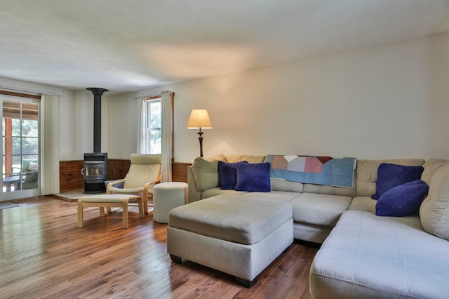 56 Averill Rd, Brookline, NH 03033 - living room featuring a wood stove, healthy amount of natural light, hardwood / wood-style flooring, and wainscoting
