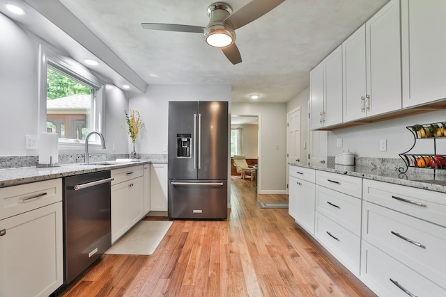 56 Averill Rd, Brookline, NH 03033 - kitchen featuring appliances with stainless steel finishes, a sink, a ceiling fan, white cabinetry, and light wood-style flooring