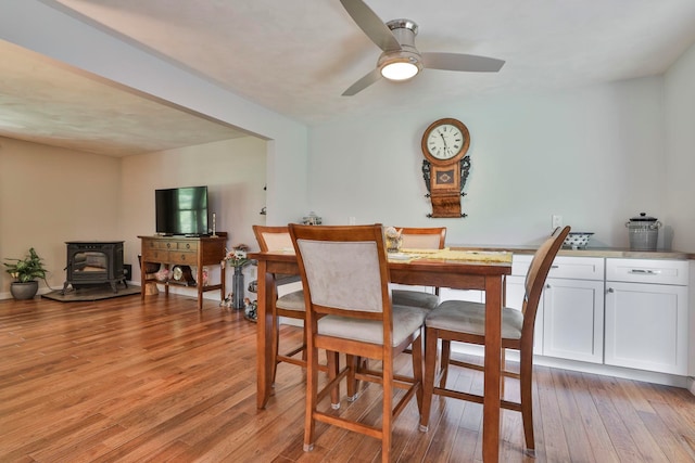 56 Averill Rd, Brookline, NH 03033 - dining room featuring a wood stove, light wood-type flooring, and ceiling fan