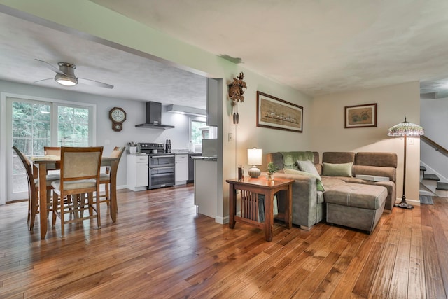 56 Averill Rd, Brookline, NH 03033 - living room with wood finished floors, healthy amount of natural light, ceiling fan, and stairway