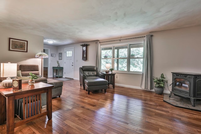 56 Averill Rd, Brookline, NH 03033 - living area featuring a wood stove, baseboards, and hardwood / wood-style flooring
