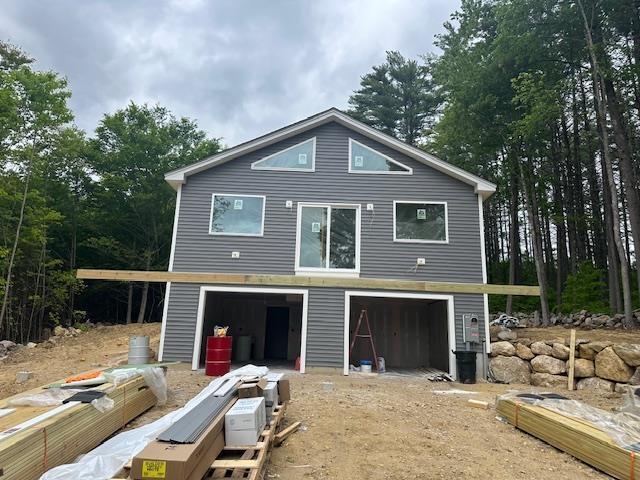76 River Rd, Pittsfield, NH 03263 - rear view of house featuring a garage