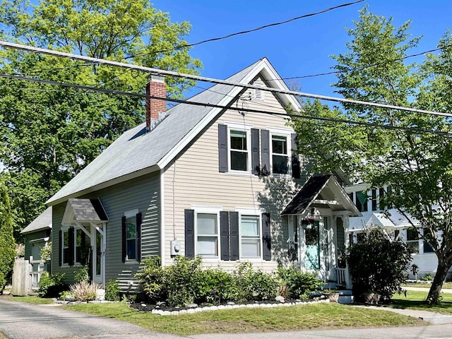 34 S Spring St, Concord, NH 03301 - view of front of home with a chimney, roof with shingles, and a front lawn