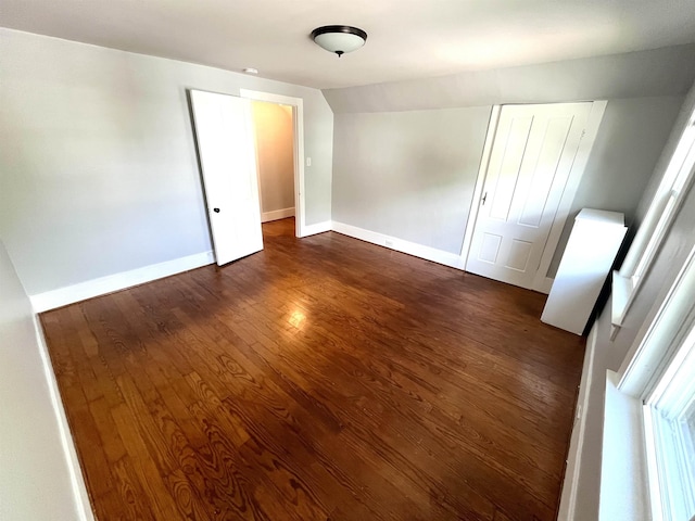 34 S Spring St, Concord, NH 03301 - empty room featuring dark wood finished floors, baseboards, and vaulted ceiling