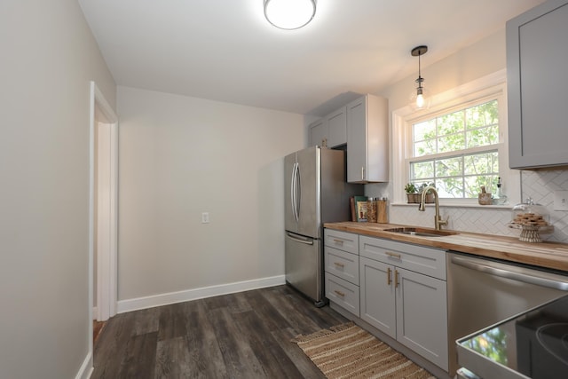 798 Hanover St, Manchester, NH 03104 - kitchen featuring butcher block counters, appliances with stainless steel finishes, a sink, gray cabinets, and tasteful backsplash