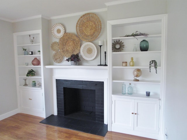 798 Hanover St, Manchester, NH 03104 - detailed view of wood finished floors, a fireplace, ornamental molding, built in shelves, and baseboards