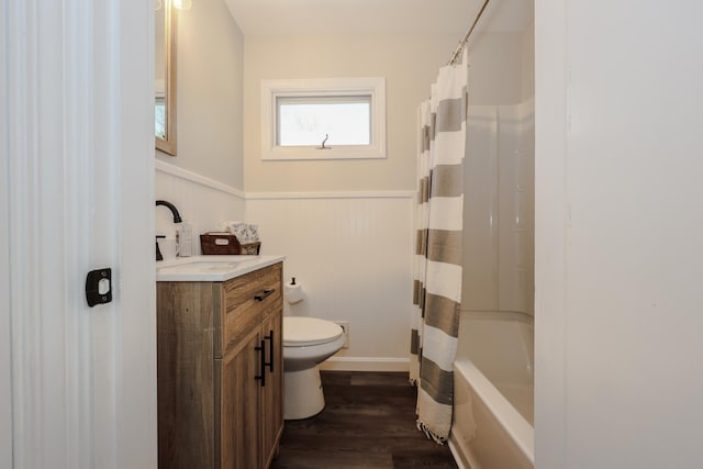 798 Hanover St, Manchester, NH 03104 - bathroom featuring toilet, vanity, wainscoting, wood finished floors, and shower / bath combination with curtain