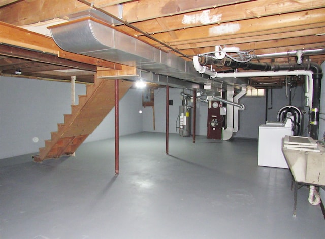 798 Hanover St, Manchester, NH 03104 - unfinished below grade area with washer / dryer, gas water heater, stairs, and heating unit