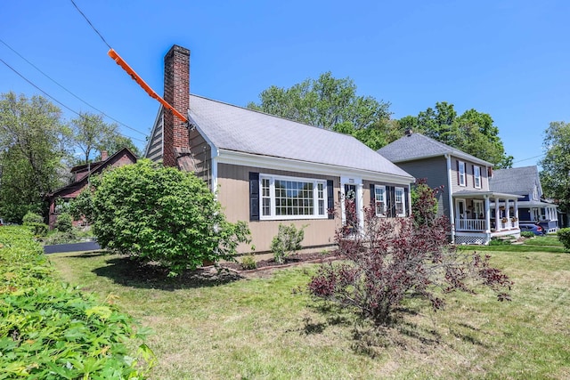 798 Hanover St, Manchester, NH 03104 - view of front of house featuring a chimney, a front lawn, and a porch