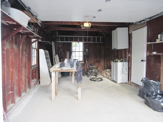 798 Hanover St, Manchester, NH 03104 - garage with a garage door opener and wooden walls
