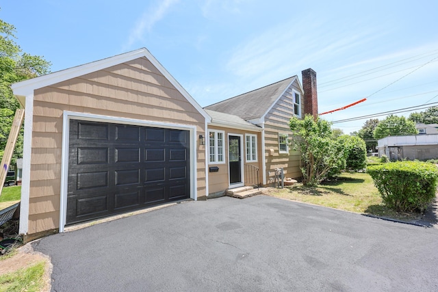 798 Hanover St, Manchester, NH 03104 - single story home featuring entry steps, driveway, a chimney, and an attached garage