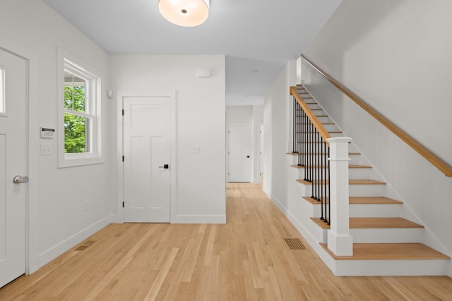 93 Stage Rd, Hampstead, NH 03841 - entrance foyer featuring light wood-type flooring, stairs, and baseboards