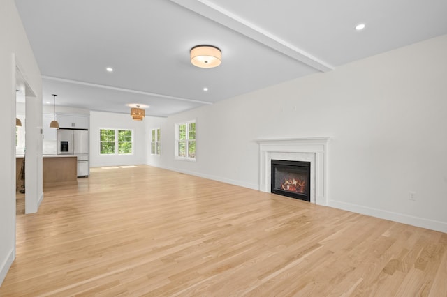 93 Stage Rd, Hampstead, NH 03841 - unfurnished living room featuring a glass covered fireplace, light wood-type flooring, recessed lighting, baseboards, and beamed ceiling