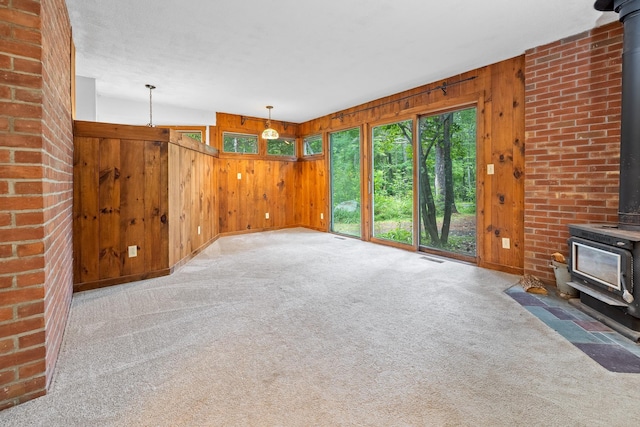 5 Dogford Rd, Hanover, NH 03750 - unfurnished living room featuring a wood stove, wooden walls, and carpet