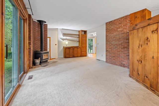 5 Dogford Rd, Hanover, NH 03750 - unfurnished living room with a wood stove, carpet, and plenty of natural light