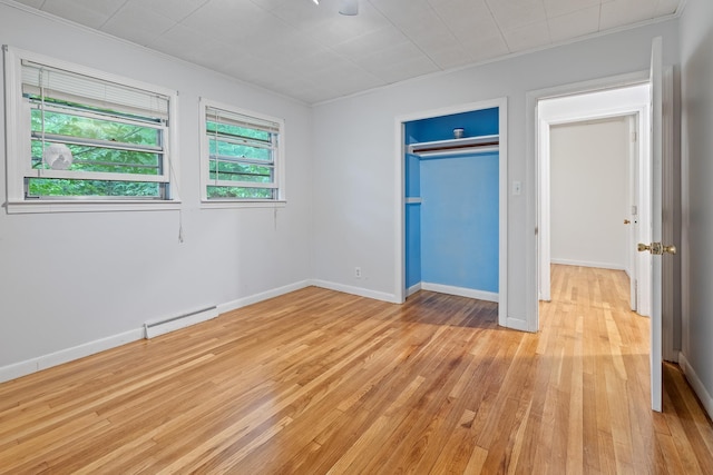 5 Dogford Rd, Hanover, NH 03750 - unfurnished bedroom featuring a baseboard radiator, ornamental molding, light wood finished floors, baseboards, and a closet