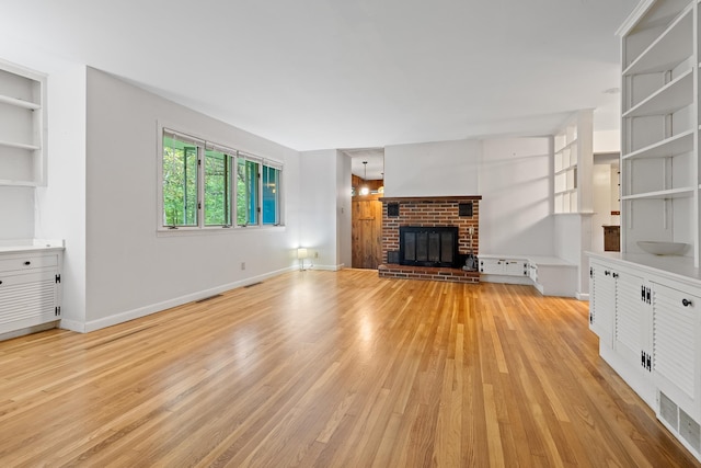 5 Dogford Rd, Hanover, NH 03750 - unfurnished living room featuring light wood-style flooring, a brick fireplace, and baseboards