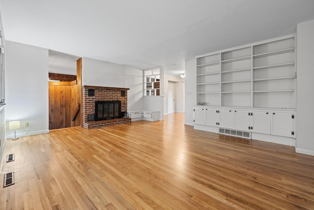 5 Dogford Rd, Hanover, NH 03750 - unfurnished living room featuring light wood-style floors, a brick fireplace, and baseboards