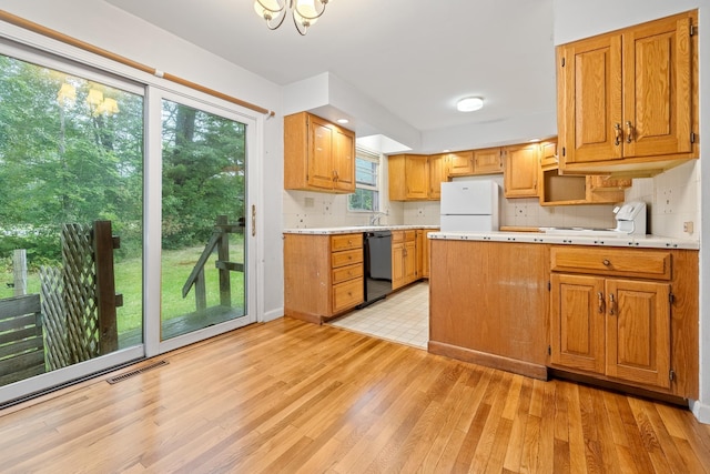 5 Dogford Rd, Hanover, NH 03750 - kitchen featuring freestanding refrigerator, black dishwasher, light wood-style floors, light countertops, and backsplash
