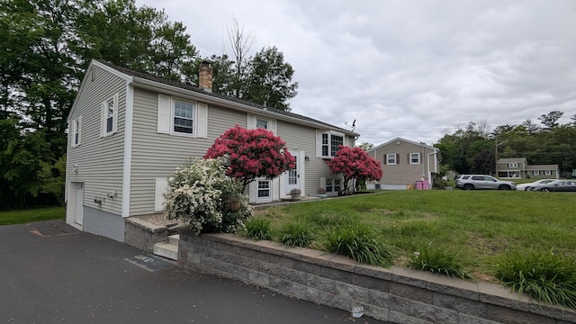 19 Bradford Dr, Salem, NH 03079 - split foyer home featuring a chimney and a front lawn