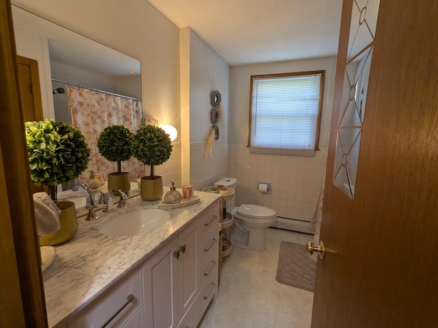 19 Bradford Dr, Salem, NH 03079 - bathroom featuring a baseboard heating unit, vanity, toilet, tile walls, and tile patterned floors