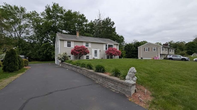 19 Bradford Dr, Salem, NH 03079 - raised ranch with a front lawn and a chimney