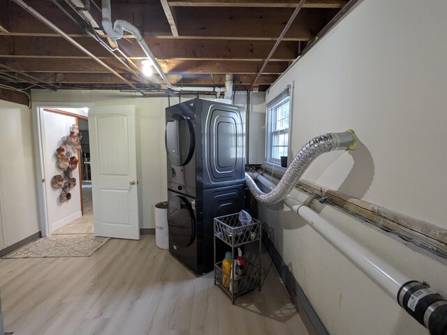 19 Bradford Dr, Salem, NH 03079 - below grade area with stacked washer and clothes dryer and wood finished floors