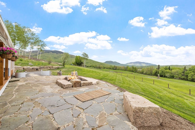 126 Stoddard Rd, Columbia, NH 03576 - view of patio / terrace with an outdoor fire pit, a rural view, and a mountain view