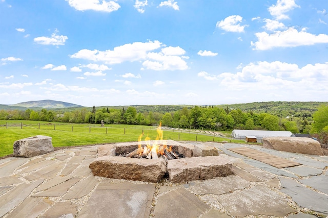 126 Stoddard Rd, Columbia, NH 03576 - view of patio / terrace with a fire pit, a view of countryside, and a mountain view