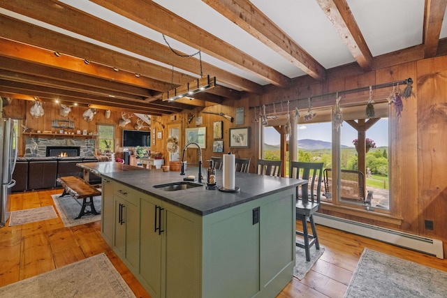 126 Stoddard Rd, Columbia, NH 03576 - kitchen with green cabinetry, a sink, a baseboard heating unit, dark countertops, and beamed ceiling