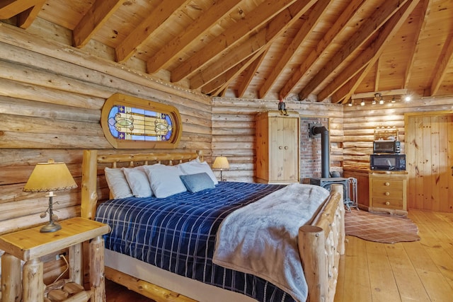 126 Stoddard Rd, Columbia, NH 03576 - bedroom featuring rustic walls, hardwood / wood-style flooring, wooden ceiling with exposed beams, and a wood stove