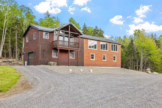 126 Stoddard Rd, Columbia, NH 03576 - view of front of home with faux log siding, driveway, an attached garage, and metal roof