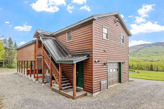 126 Stoddard Rd, Columbia, NH 03576 - view of home's exterior featuring a garage, gravel driveway, stairs, metal roof, and faux log siding