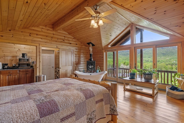 126 Stoddard Rd, Columbia, NH 03576 - bedroom featuring wooden ceiling, access to exterior, a wood stove, light wood-type flooring, and wood walls