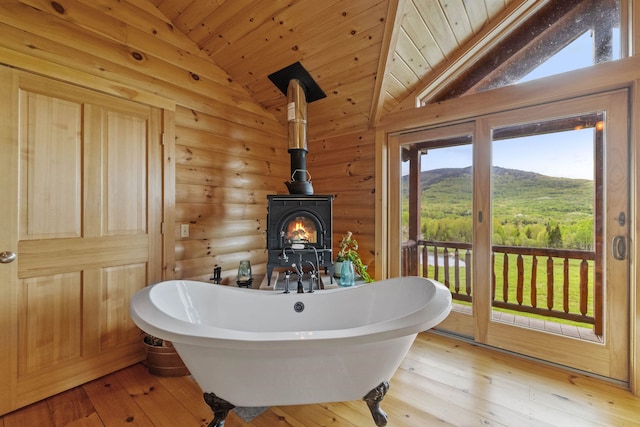 126 Stoddard Rd, Columbia, NH 03576 - full bathroom with lofted ceiling, a freestanding tub, rustic walls, wood ceiling, and hardwood / wood-style floors