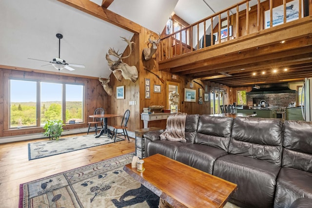 126 Stoddard Rd, Columbia, NH 03576 - living area with ceiling fan, healthy amount of natural light, wood-type flooring, wood walls, and high vaulted ceiling