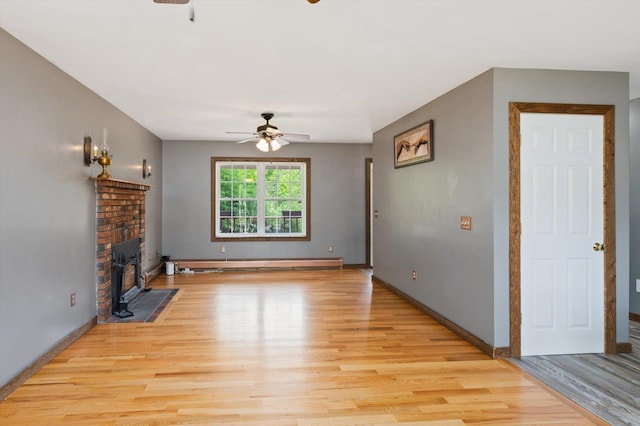 53 Crestview Dr, Jaffrey, NH 03452 - unfurnished living room with ceiling fan, light wood-style floors, baseboards, and a baseboard heating unit
