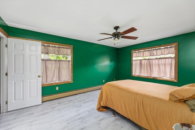 53 Crestview Dr, Jaffrey, NH 03452 - bedroom featuring a baseboard radiator, wood finished floors, a ceiling fan, and baseboards