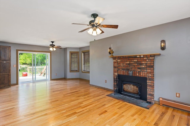 53 Crestview Dr, Jaffrey, NH 03452 - unfurnished living room with a baseboard radiator, a ceiling fan, wood finished floors, a brick fireplace, and baseboards