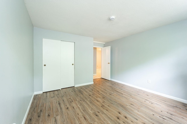 17 Silvestri Cir Unit 4, Derry, NH 03038 - unfurnished bedroom featuring wood finished floors, baseboards, and a closet