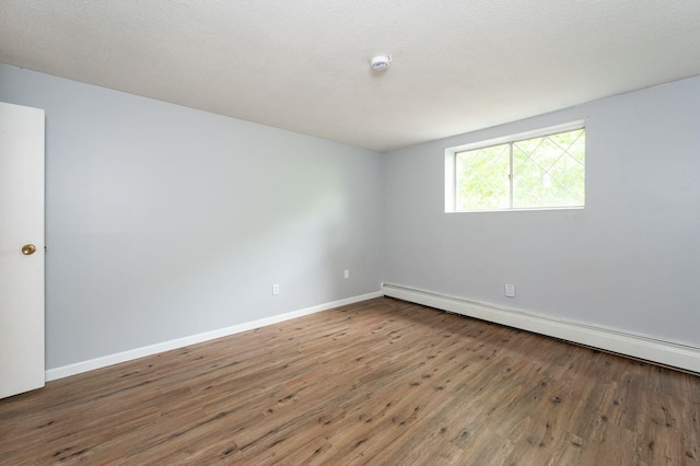 17 Silvestri Cir Unit 4, Derry, NH 03038 - unfurnished room featuring a baseboard heating unit, wood finished floors, baseboards, and a smoke detector