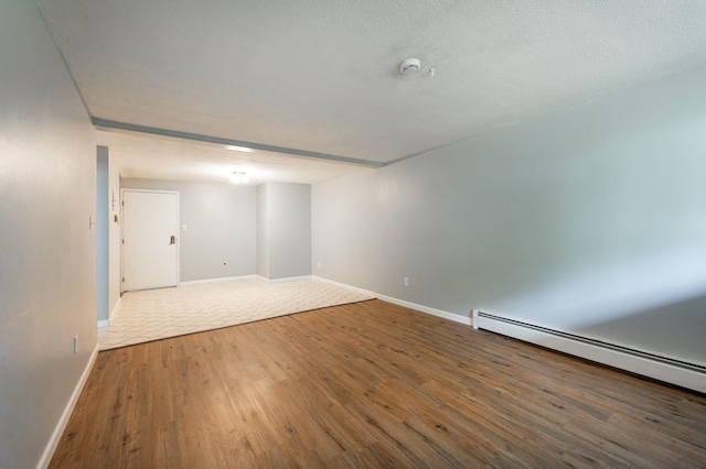 17 Silvestri Cir Unit 4, Derry, NH 03038 - unfurnished room featuring wood finished floors, baseboards, baseboard heating, and a smoke detector
