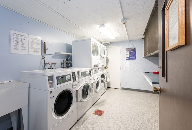 17 Silvestri Cir Unit 4, Derry, NH 03038 - community laundry featuring stacked washing machine and dryer, separate washer and dryer, baseboards, a textured ceiling, and a textured wall