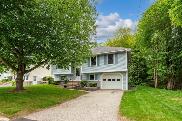 40 Trolley St, Manchester, NH 03103 - bi-level home featuring an attached garage, asphalt driveway, and a front yard