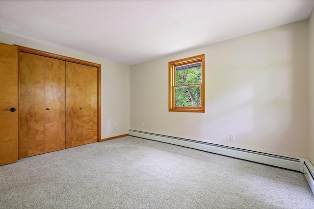 40 Trolley St, Manchester, NH 03103 - unfurnished bedroom featuring carpet, baseboard heating, a closet, and baseboards
