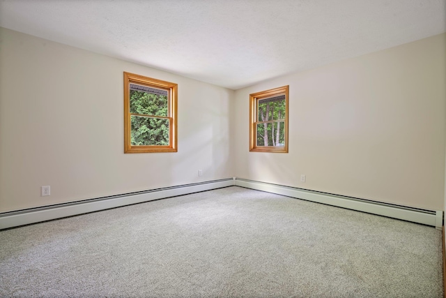 40 Trolley St, Manchester, NH 03103 - spare room with healthy amount of natural light, carpet floors, baseboard heating, and baseboards